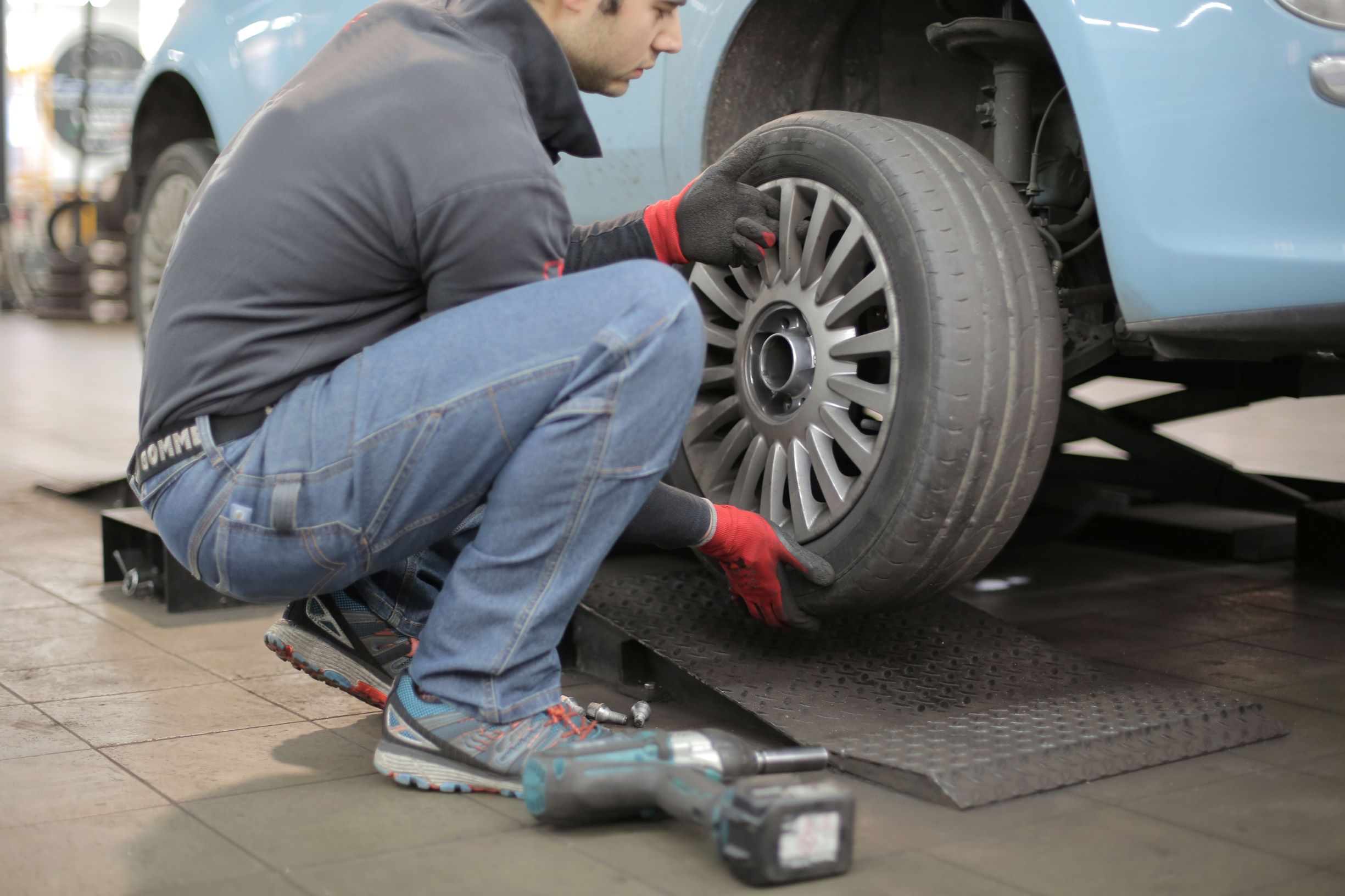 A car mechanic inspecting a car